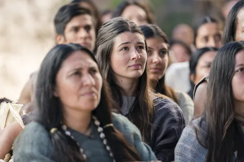 A young woman listens as Alma the Younger preaches to the people of Gideon.