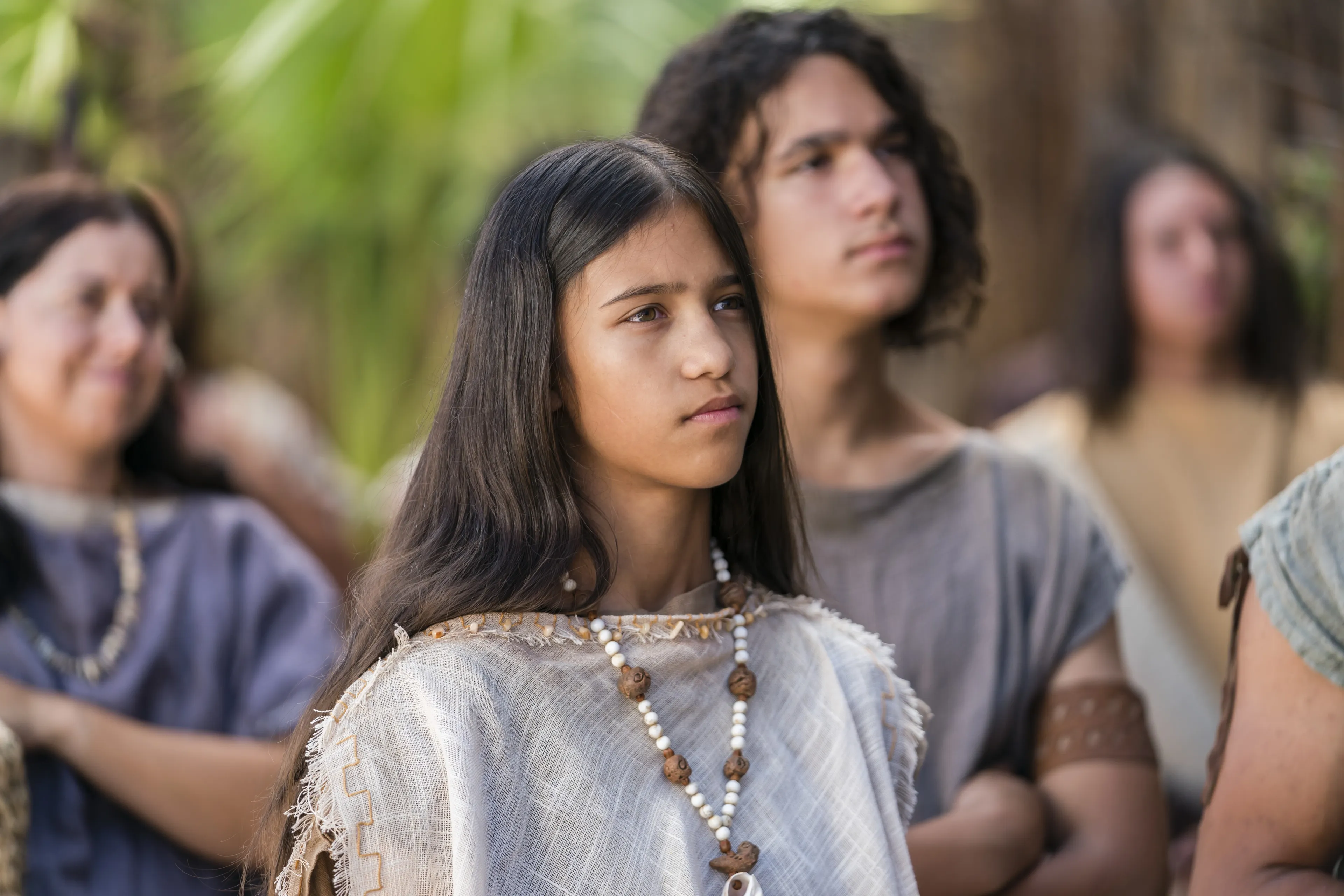 A young woman listens as Alma the Younger preaches to the people of Gideon.