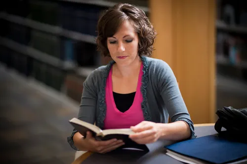 woman researching in books
