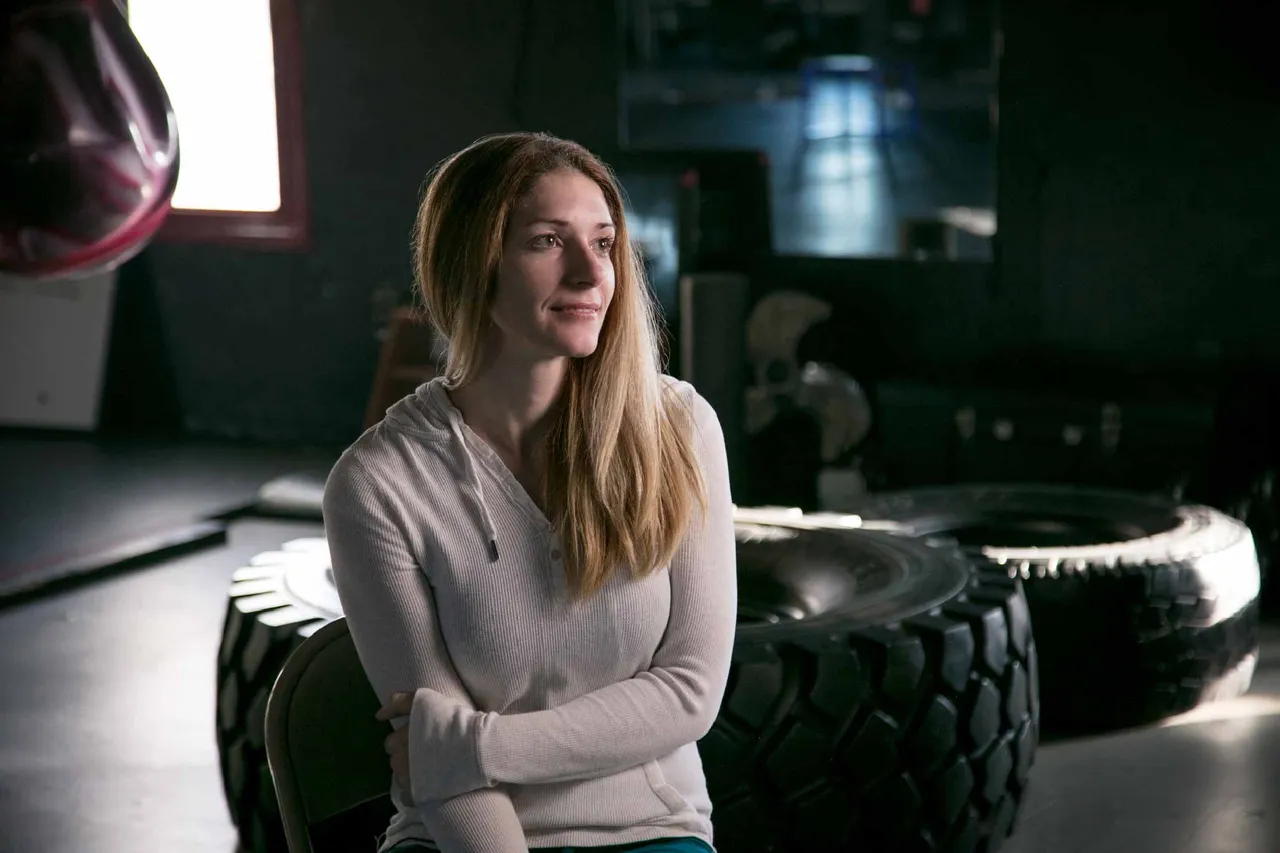 Lizzy smiling with her arms folded discusses the gospel of Jesus Christ