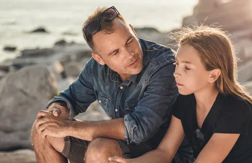 father talking to his daughter