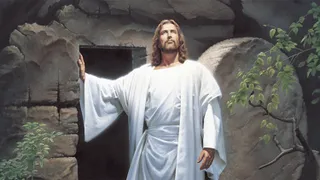 The resurrected Jesus Christ (dressed in white robes) standing at the entrance to the Garden Tomb. Christ is portrayed looking toward the heavens.