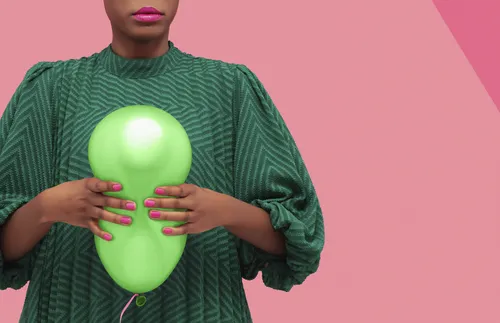 women squeezing balloon