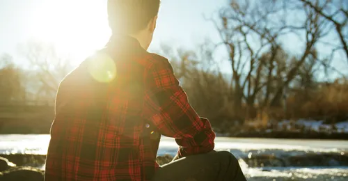 young man by a river