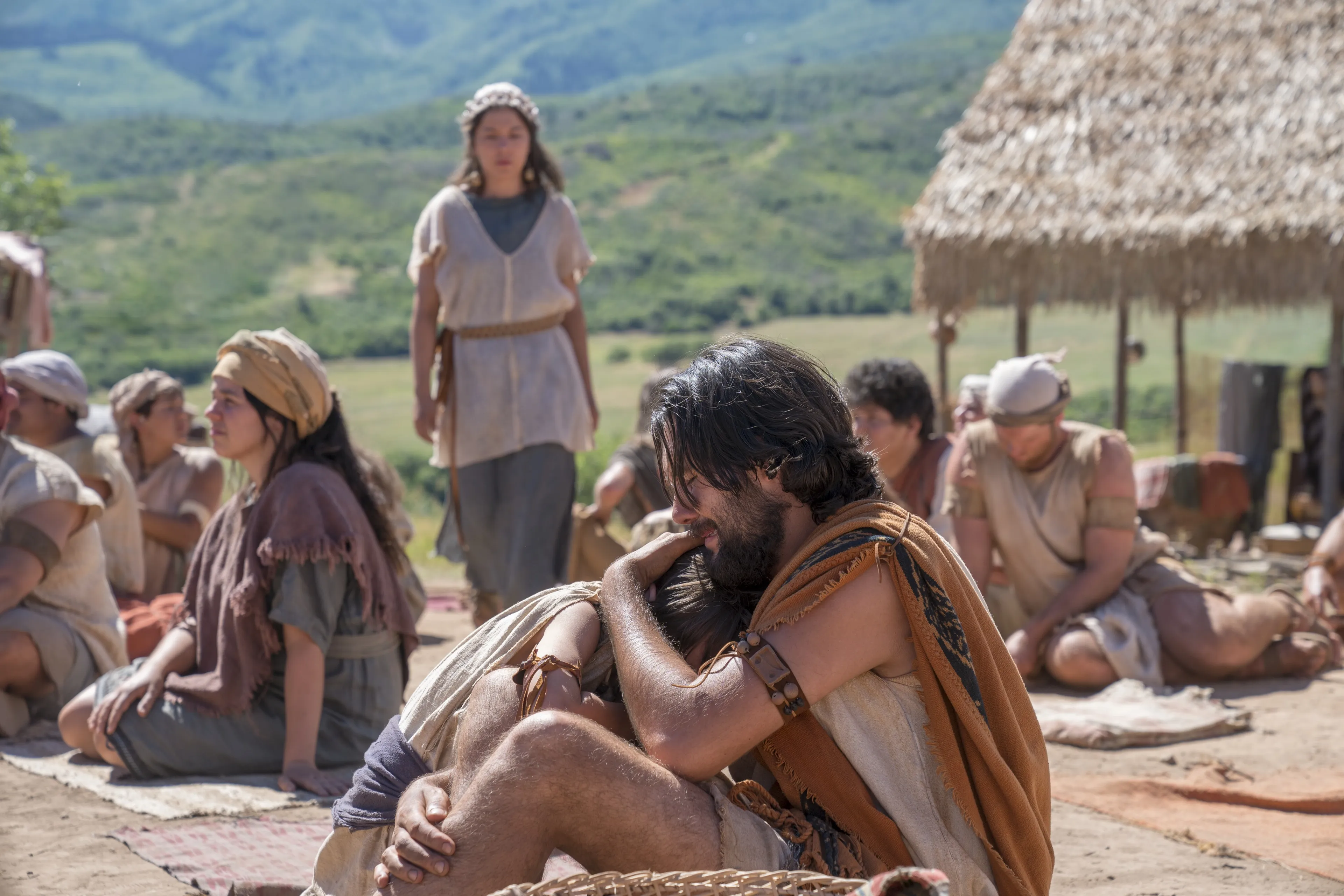A Nephite man hugs his son after listening to Jacob teach.