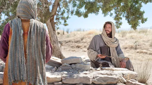 Jesus and a woman speaking at a well