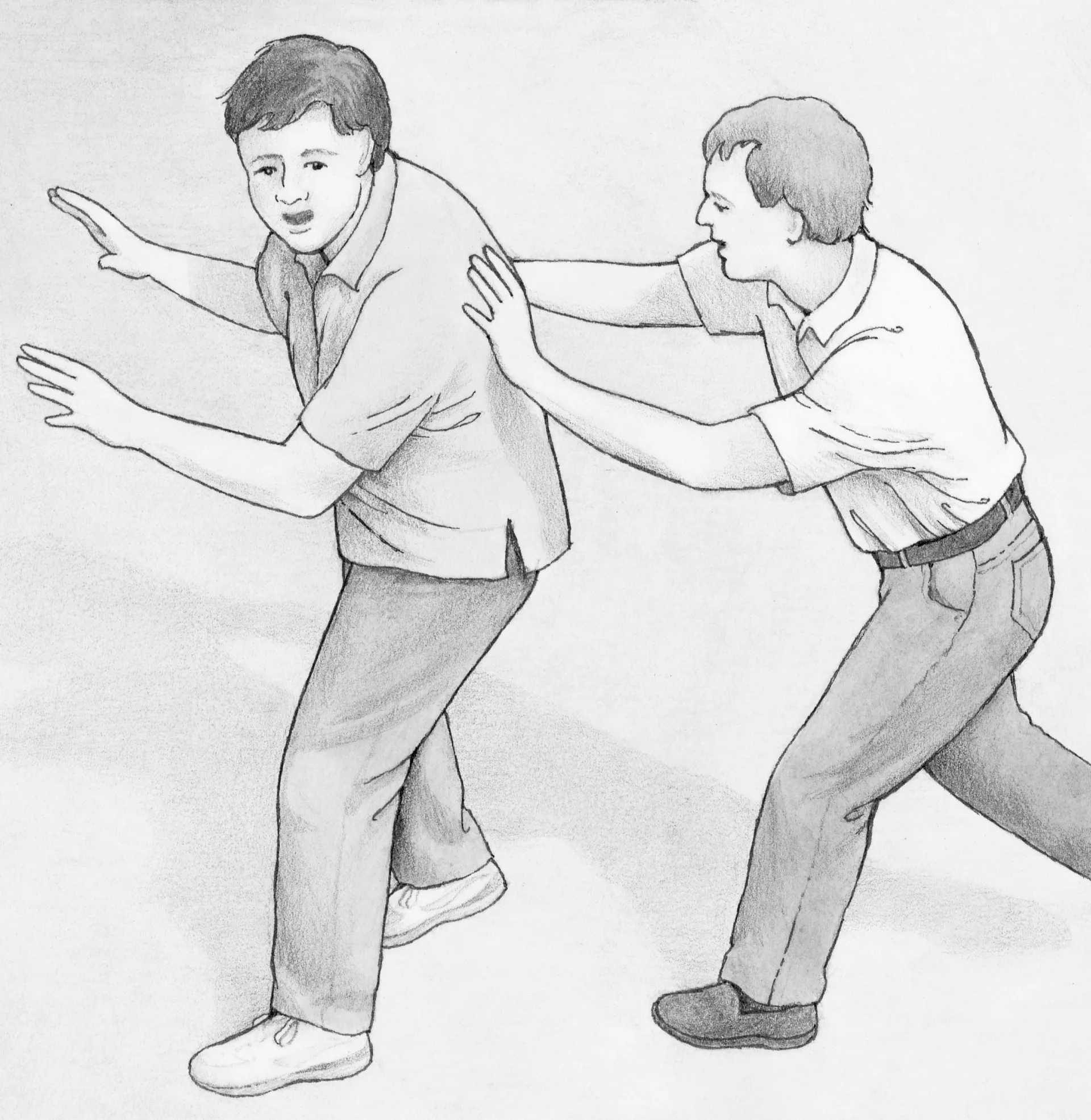 A boy pushing another boy.