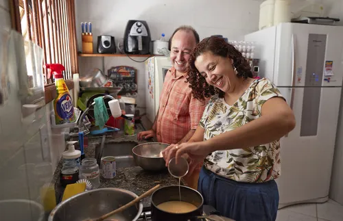 man and woman working together in kitchen