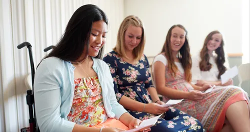 Young women in Sunday School class responding to a special needs young woman.