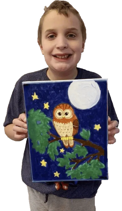 Boy holding painting of owl