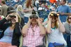 three people holding binoculars