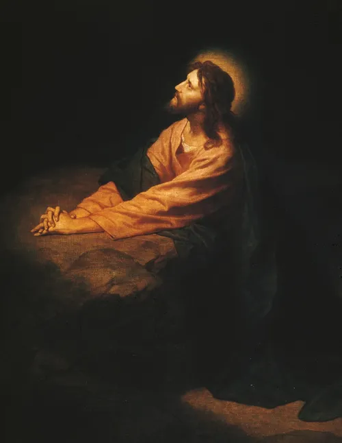 Jesus Christ kneeling as He prays and atones in the Garden of Gethsemane