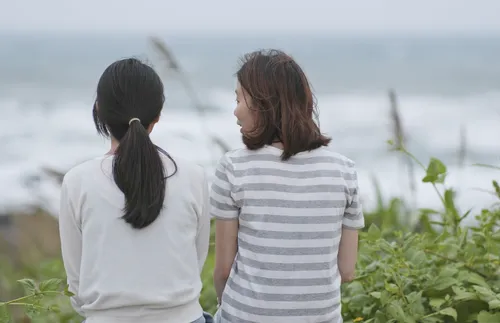 two women sitting next to each other