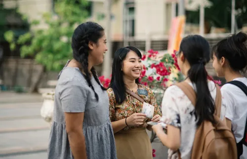 Sister missionaries talking to others outside