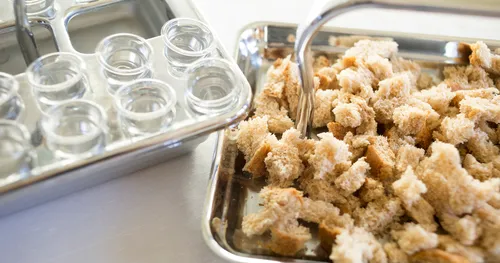 Sacrament trays with broken bread and water ready for the sacrament.