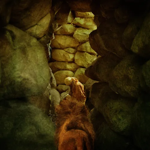 Daniel praying in the lions’ den while a lion approaches him