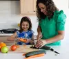 Woman and girl cutting vegetables in a kitchen