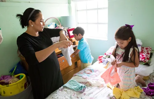 a mother and her children working on laundry