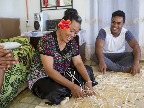 woman weaving straw