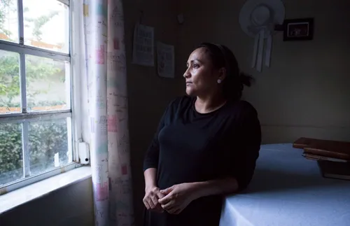 woman looking out a window