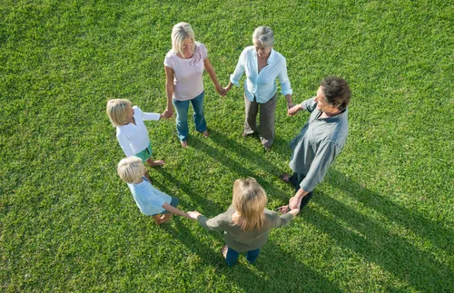 a family standing together holding hands and forming a circle