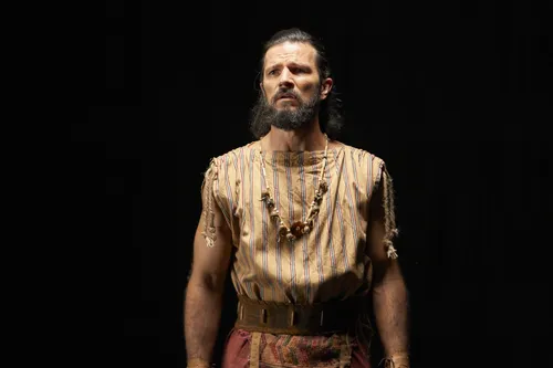 Alma the Younger is alone in a desolate space.