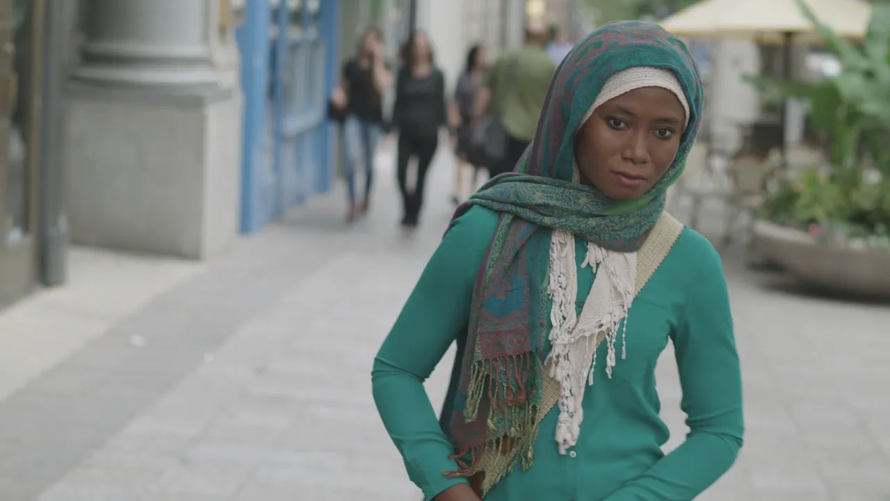 A woman walks down a street helping a beaten man by taking him to the hospital following the example of Jesus Christ