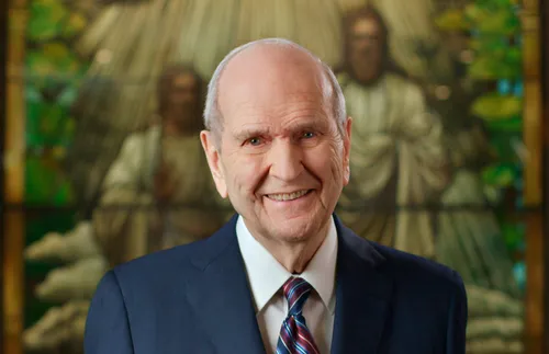 portrait of Russell M. Nelson, with stained-glass image of the Father and the Son in the background