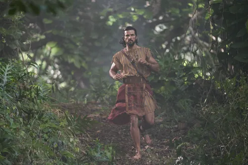 Alma the Younger walks through the woods.