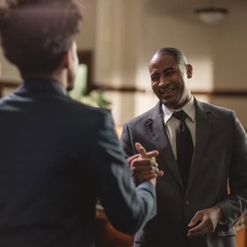 two smiling men shaking hands