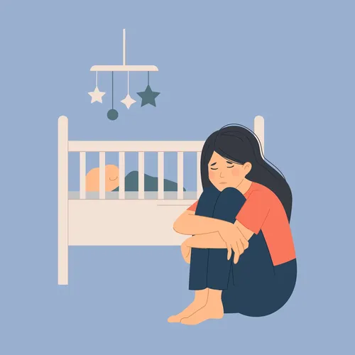a mother sitting by her baby’s cradle and looking sad