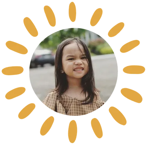 A little girl holding flowers.