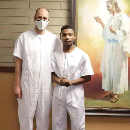 man and young man in baptismal clothes