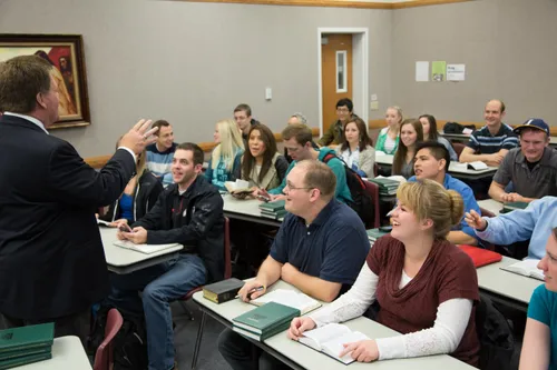 man teaching students