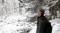 A woman hiking through the snow