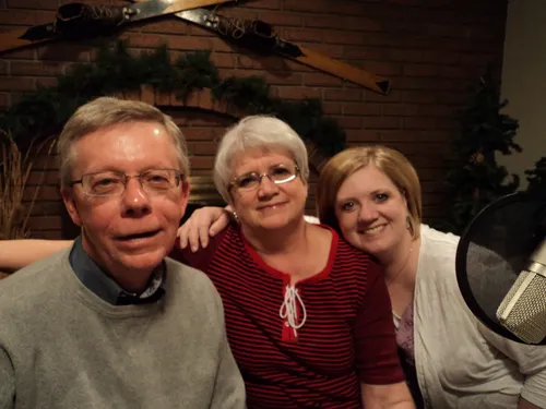 A family in front of a fireplace.
