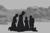 family praying in the desert