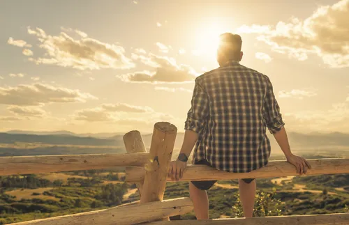 man sitting on a fence