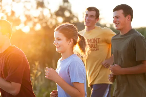 Young men and young women jogging in the outdoors.