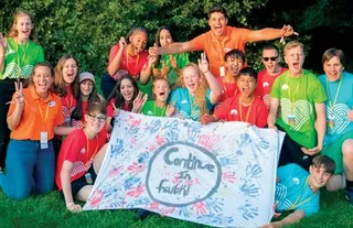 group of young men and young women holding a banner