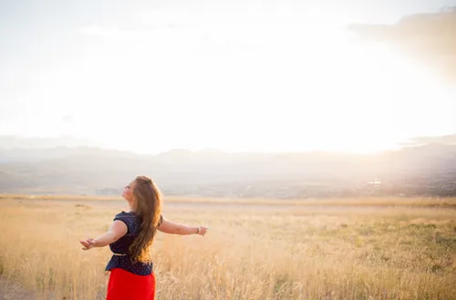 young adult woman standing in field