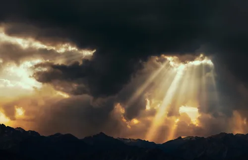 rays of light shining through dark clouds