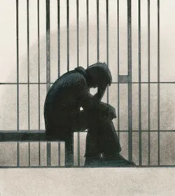 homme derrière des barreaux