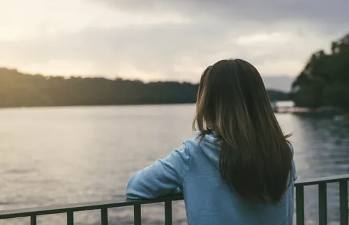 young woman looking out over the water