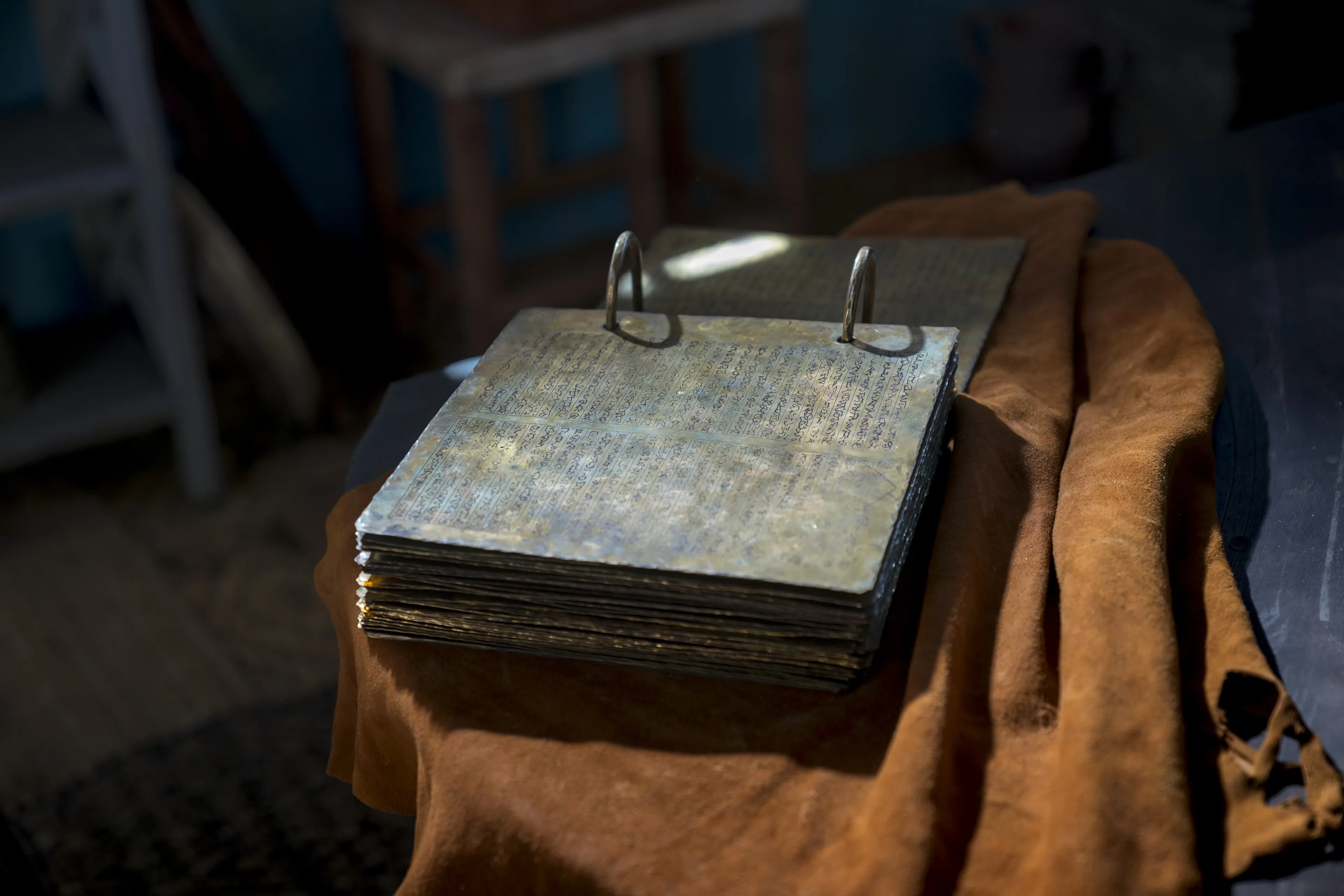 The brass plates sit open on a table.