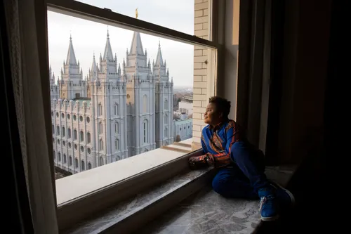 young man looking out window at the Salt Lake Temple