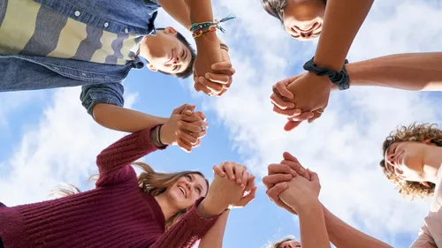 youth holding hands in a circle