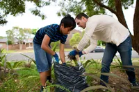 A father and a son do service for a neighbor sharing the example of Jesus Christ