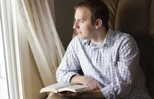 man holding scriptures