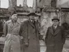 Elder Benson around 1946, standing with two missionary companions in long coats and hats in Europe.